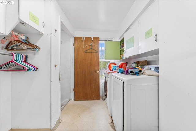 laundry room with cabinets and washing machine and clothes dryer