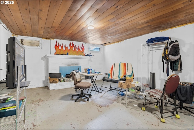 interior space featuring concrete floors, wood ceiling, and a fireplace