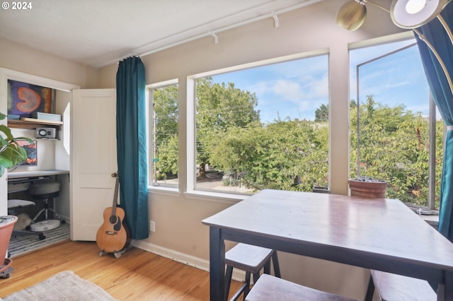 interior space with baseboards and wood finished floors