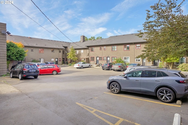 uncovered parking lot featuring a residential view