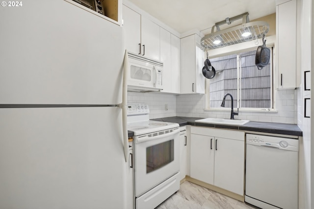 kitchen with white appliances, white cabinets, decorative backsplash, marble finish floor, and a sink