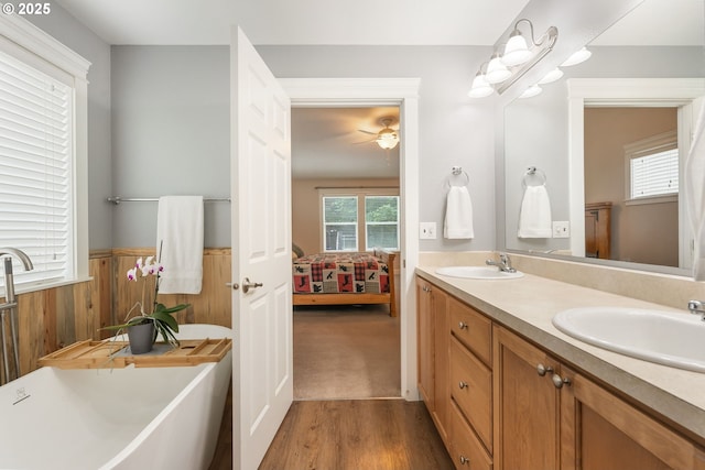 31529 SE Eagle Cliff Ln, Eagle Creek, OR 97022 - ensuite bathroom featuring double vanity, wood finished floors, ceiling fan, a wainscoted wall, and wooden walls