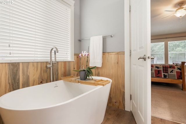 31529 SE Eagle Cliff Ln, Eagle Creek, OR 97022 - ensuite bathroom featuring a freestanding tub, wainscoting, wood walls, a sink, and wood finished floors