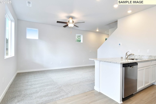 kitchen featuring visible vents, a sink, white cabinetry, dishwasher, and ceiling fan