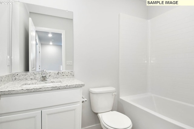 bathroom featuring bathing tub / shower combination, toilet, and vanity