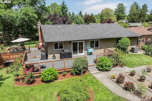 2648 SE Risley Ave, Milwaukie, OR 97267 - back of property with roof with shingles, a wooden deck, a chimney, and outdoor dining area