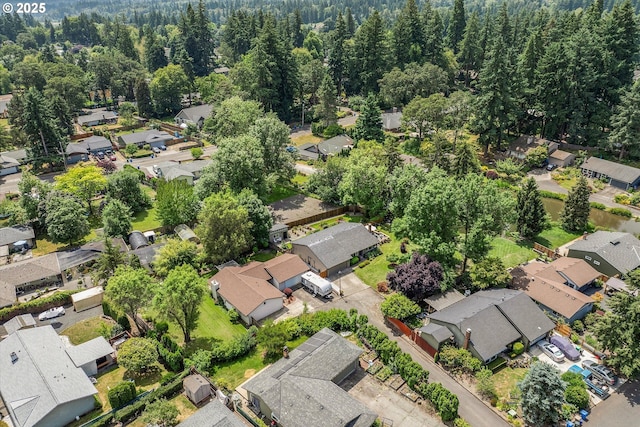 2648 SE Risley Ave, Milwaukie, OR 97267 - aerial view of property and surrounding area featuring nearby suburban area and a heavily wooded area