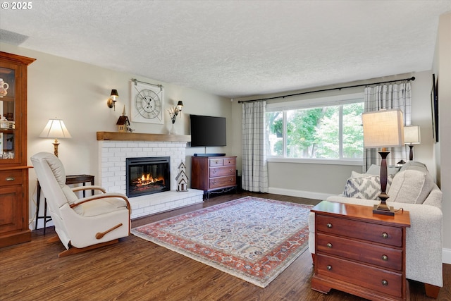 2648 SE Risley Ave, Milwaukie, OR 97267 - living room with dark wood-style floors, a fireplace, and a textured ceiling