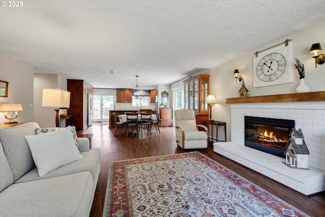 2648 SE Risley Ave, Milwaukie, OR 97267 - living room featuring a fireplace, dark wood-style floors, and a textured ceiling