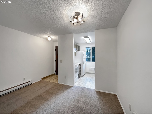 spare room with a baseboard radiator, light colored carpet, baseboards, and a textured ceiling