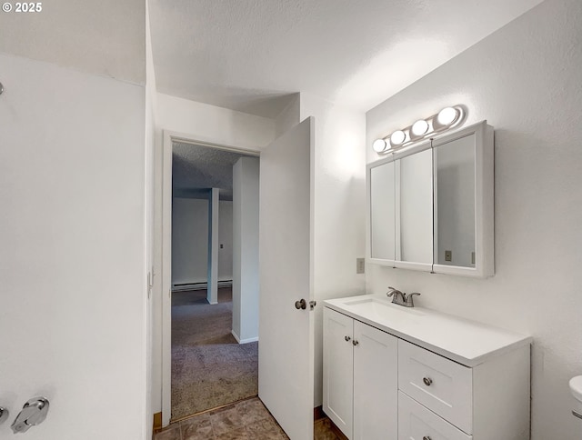 bathroom featuring toilet, a baseboard radiator, vanity, and a textured ceiling