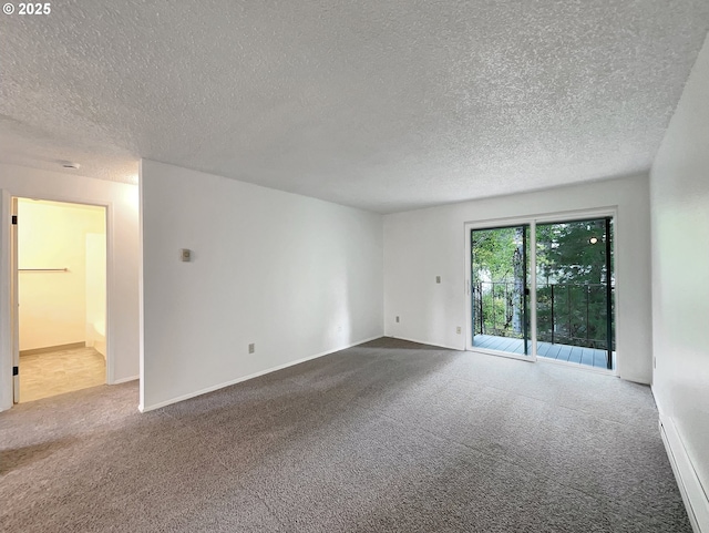 spare room with carpet floors and a textured ceiling