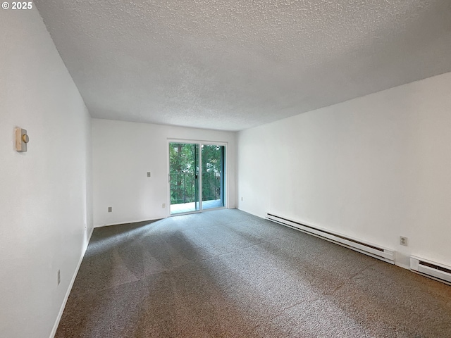 carpeted spare room featuring a baseboard heating unit and a textured ceiling