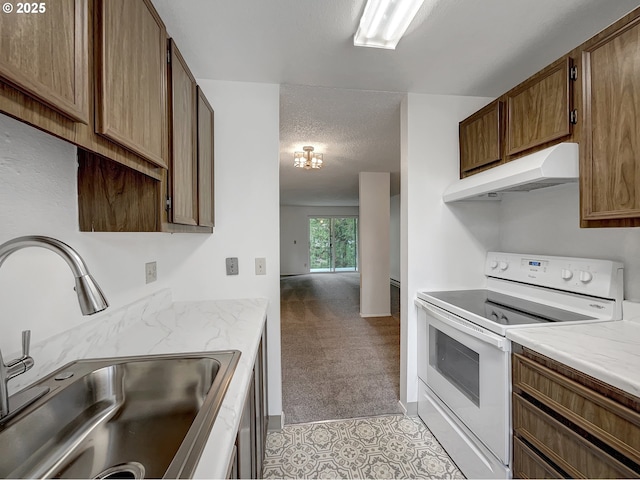 kitchen with a textured ceiling, under cabinet range hood, white range with electric stovetop, light colored carpet, and a sink