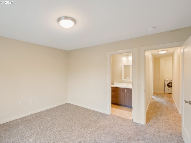 10827 E Burnside St, Portland, OR 97035 - unfurnished bedroom with washer / dryer, light carpet, a sink, baseboards, and ensuite bathroom