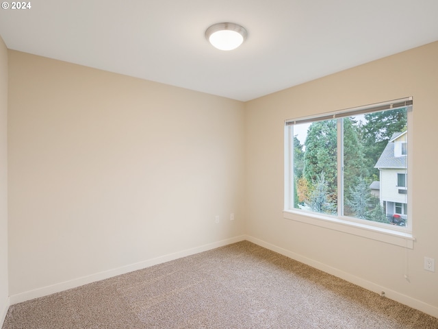 10827 E Burnside St, Portland, OR 97035 - spare room featuring light carpet and baseboards