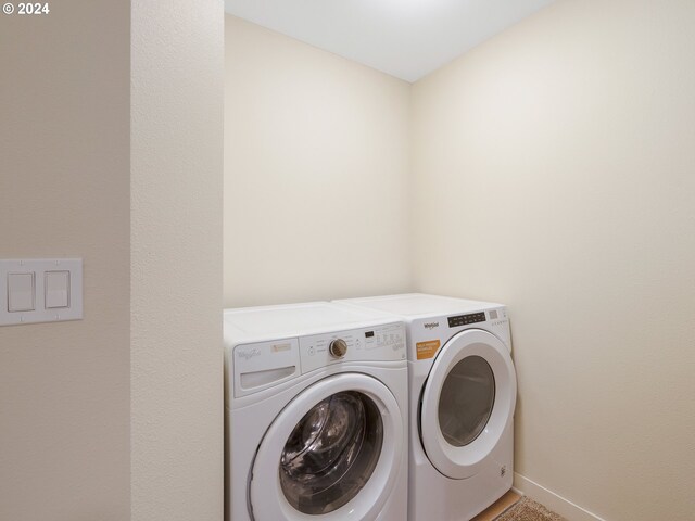10827 E Burnside St, Portland, OR 97035 - laundry room with washer and clothes dryer and baseboards