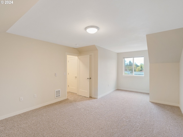 bonus room with light colored carpet