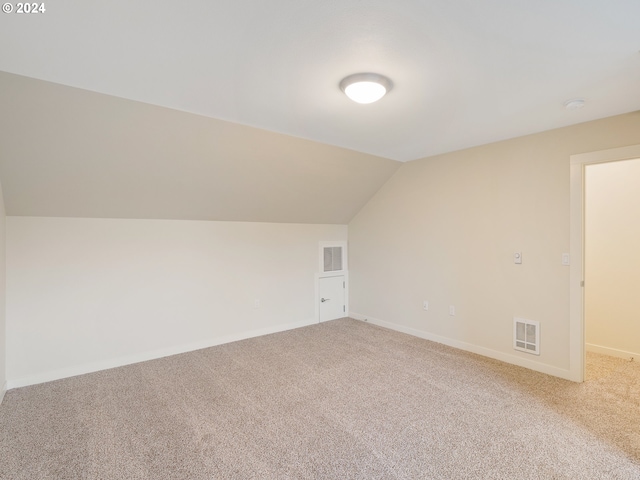 10827 E Burnside St, Portland, OR 97035 - bonus room with carpet floors, lofted ceiling, and baseboards