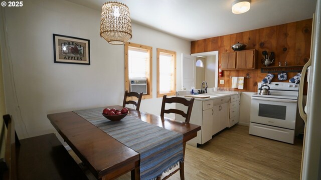 145 E Franklin Ave, Dayville, OR 97825 - kitchen featuring white electric range, light wood-style flooring, light countertops, a chandelier, and cooling unit