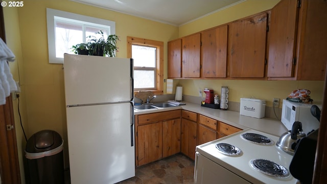 145 E Franklin Ave, Dayville, OR 97825 - kitchen featuring white appliances, light countertops, brown cabinetry, and stone finish flooring