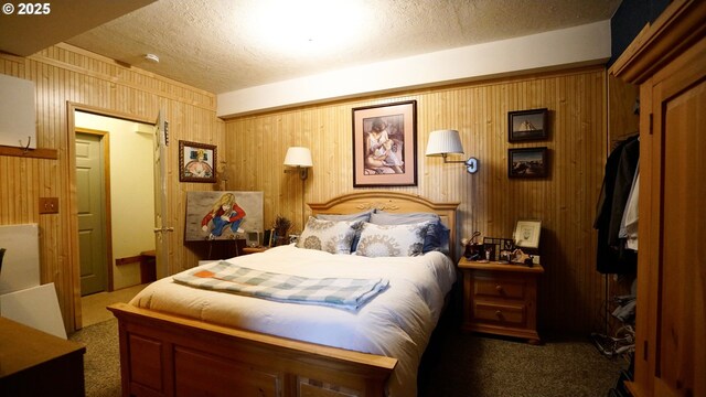 145 E Franklin Ave, Dayville, OR 97825 - bedroom featuring carpet flooring, a textured ceiling, and wooden walls