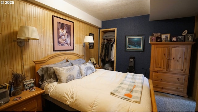 145 E Franklin Ave, Dayville, OR 97825 - carpeted bedroom with a closet, wood walls, and a textured ceiling