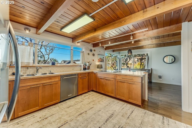 kitchen with sink, light hardwood / wood-style flooring, dishwasher, tasteful backsplash, and kitchen peninsula