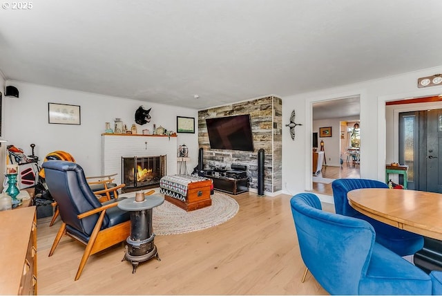 living room with light wood-type flooring and a fireplace