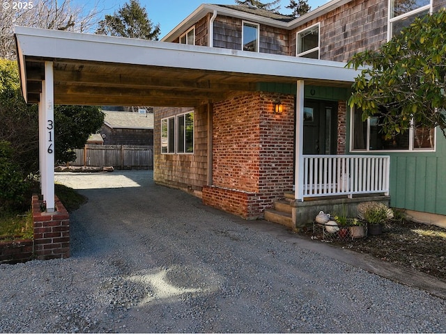 view of front of house with a carport and a porch