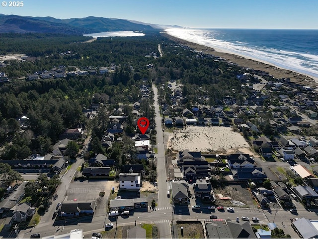 birds eye view of property featuring a beach view and a water and mountain view