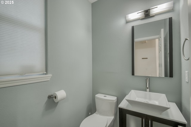 bathroom with toilet and vanity