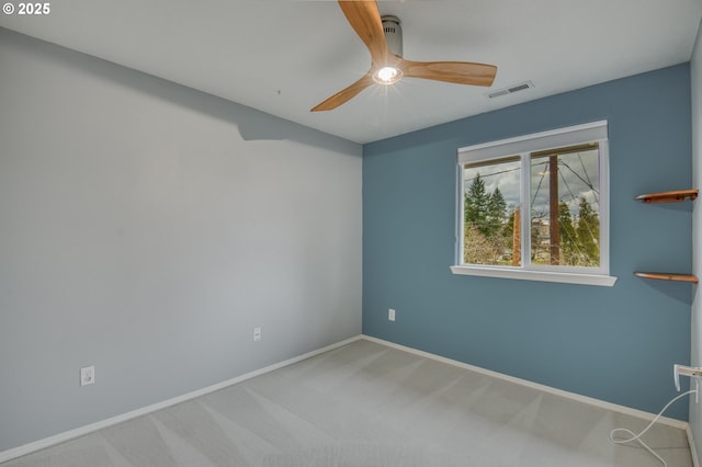 spare room with baseboards, visible vents, carpet floors, and ceiling fan