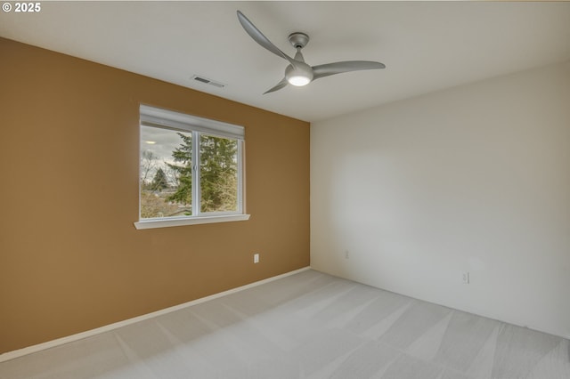 unfurnished room featuring light carpet, visible vents, and ceiling fan