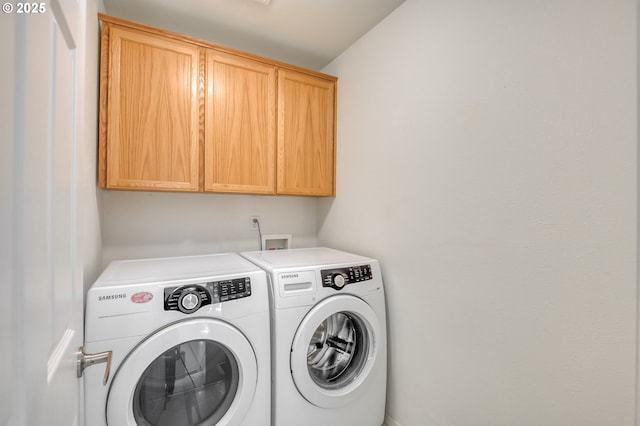 laundry room with cabinet space and independent washer and dryer