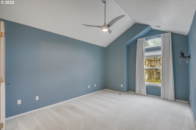 interior space featuring ceiling fan, baseboards, carpet, and vaulted ceiling