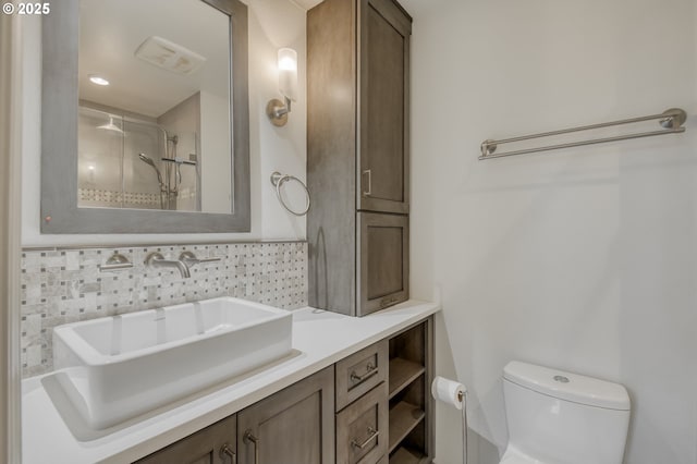 bathroom with vanity, toilet, and a shower