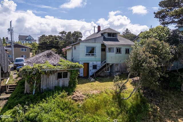 118 SW Brook St, Newport, OR 97365 - rear view of property with stairs and a chimney