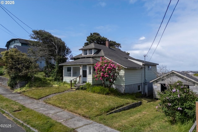 118 SW Brook St, Newport, OR 97365 - bungalow with a chimney, a front lawn, and roof with shingles