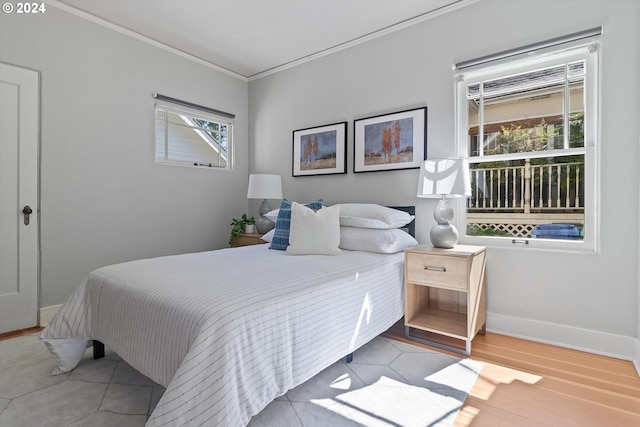 bedroom with baseboards and ornamental molding