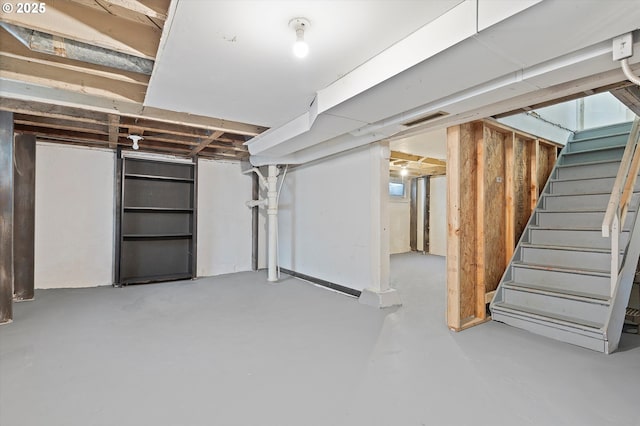 unfinished below grade area with visible vents and stairs