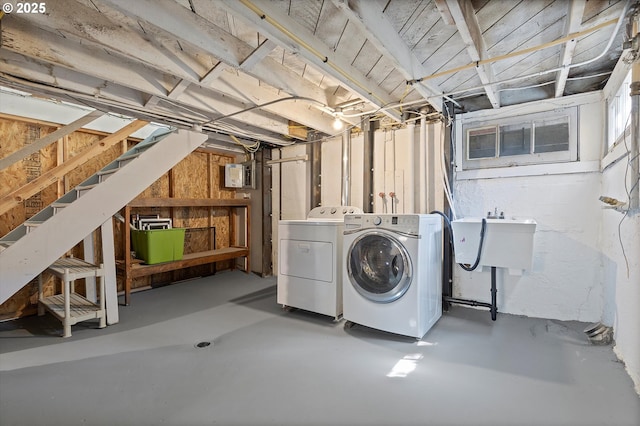 unfinished below grade area featuring a sink, washer and dryer, and stairway