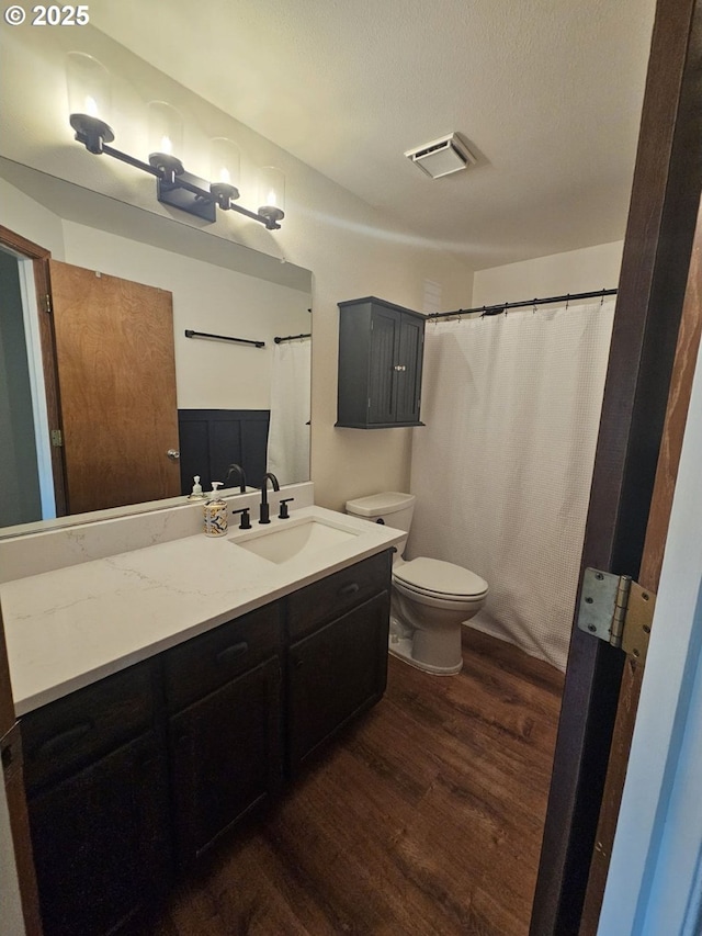 5740 SE Golden Rd, Hillsboro, OR 97123 - full bathroom with wood finished floors, toilet, vanity, and a textured ceiling