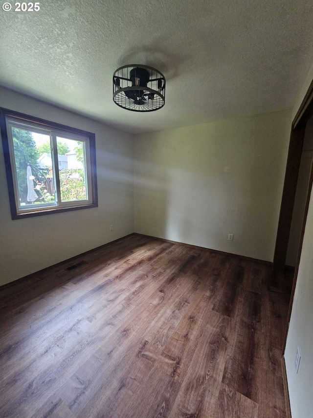 5740 SE Golden Rd, Hillsboro, OR 97123 - spare room featuring dark wood finished floors and a textured ceiling