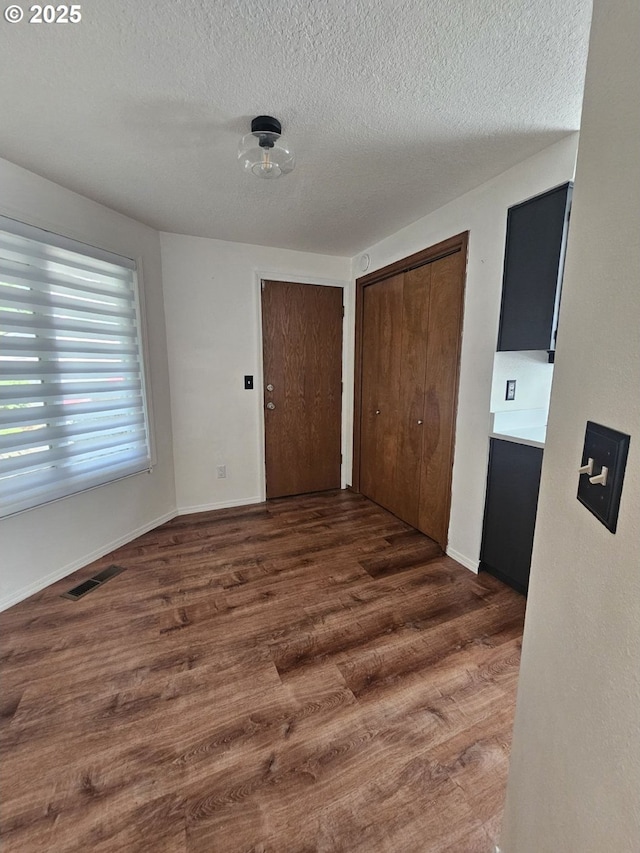 5740 SE Golden Rd, Hillsboro, OR 97123 - foyer entrance featuring wood finished floors, a textured ceiling, and baseboards