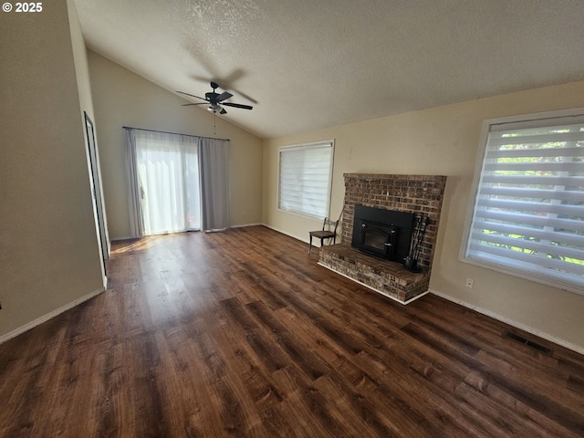 5740 SE Golden Rd, Hillsboro, OR 97123 - unfurnished living room with a ceiling fan, lofted ceiling, dark wood-style flooring, a textured ceiling, and baseboards