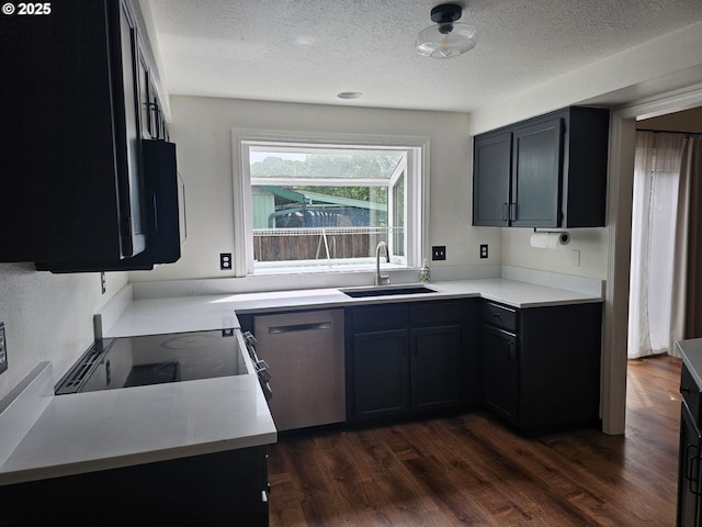 5740 SE Golden Rd, Hillsboro, OR 97123 - kitchen with a sink, dishwasher, a textured ceiling, dark wood finished floors, and light countertops