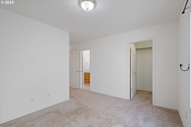 1939 NE Harewood Pl, Hillsboro, OR 97124 - unfurnished bedroom featuring light carpet, a spacious closet, baseboards, ensuite bath, and a closet
