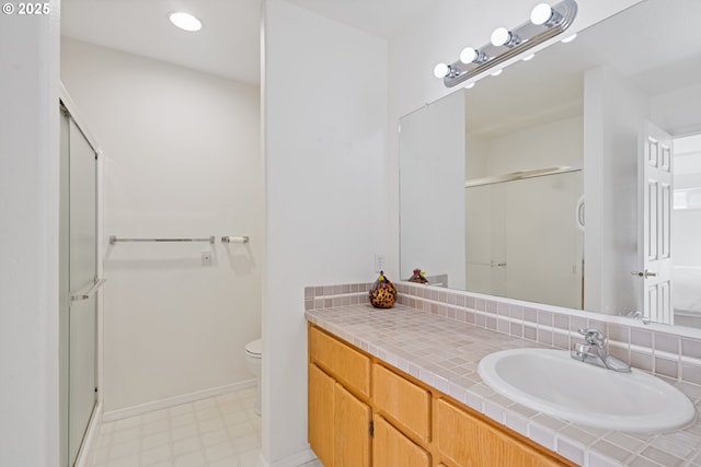 1939 NE Harewood Pl, Hillsboro, OR 97124 - bathroom featuring a stall shower, tile patterned floors, toilet, vanity, and recessed lighting