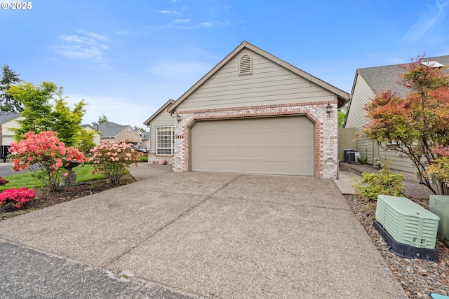 1939 NE Harewood Pl, Hillsboro, OR 97124 - ranch-style house featuring brick siding, driveway, central AC unit, and a garage